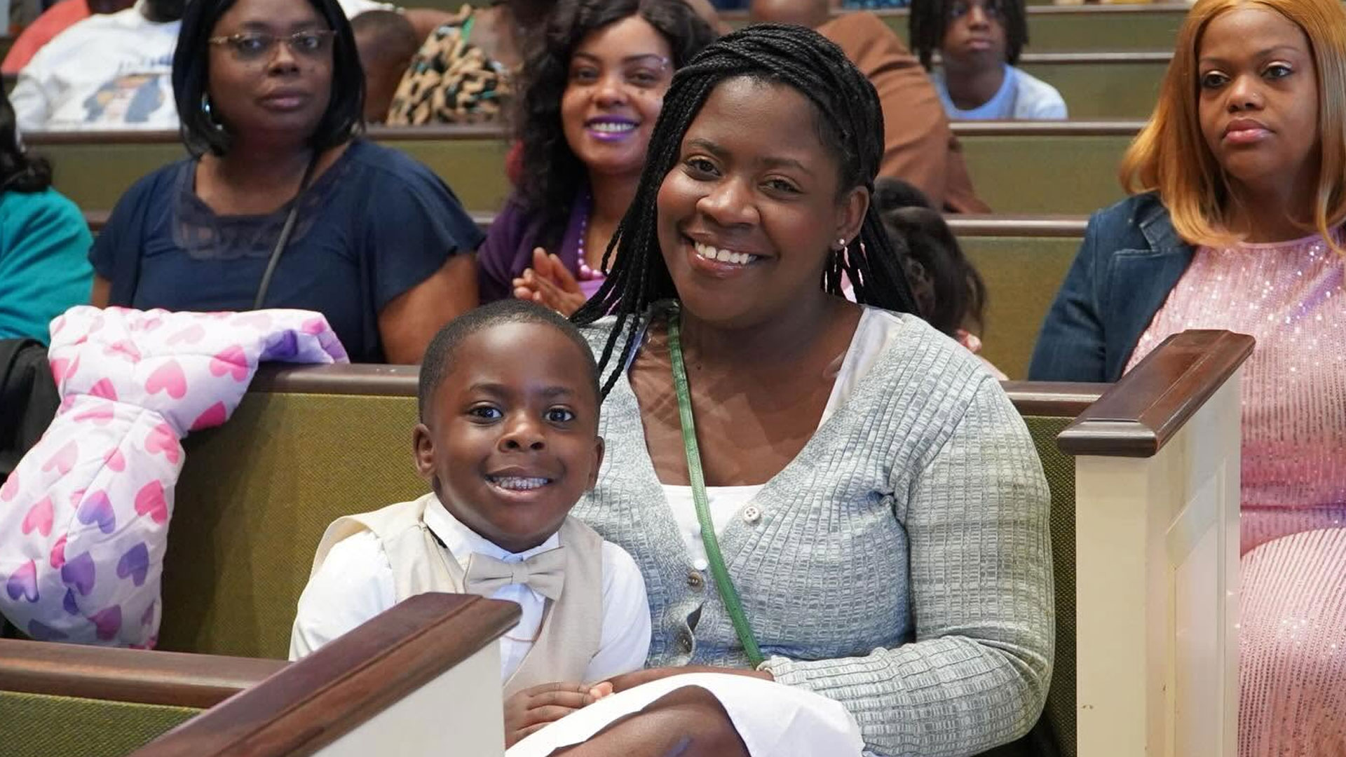 Mother and son smiling together at Brown