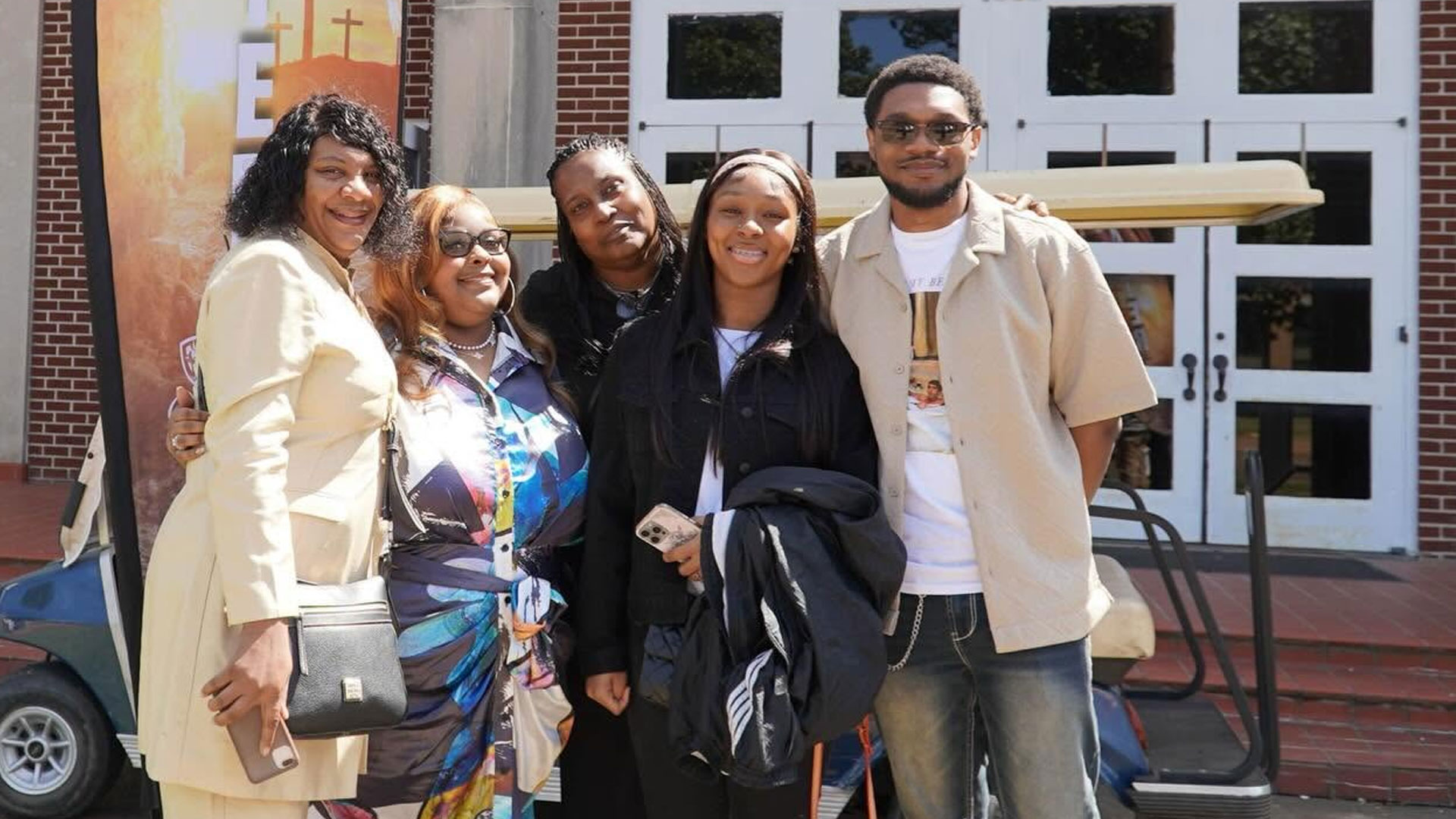 Brown members gathered together as family outside the sanctuary